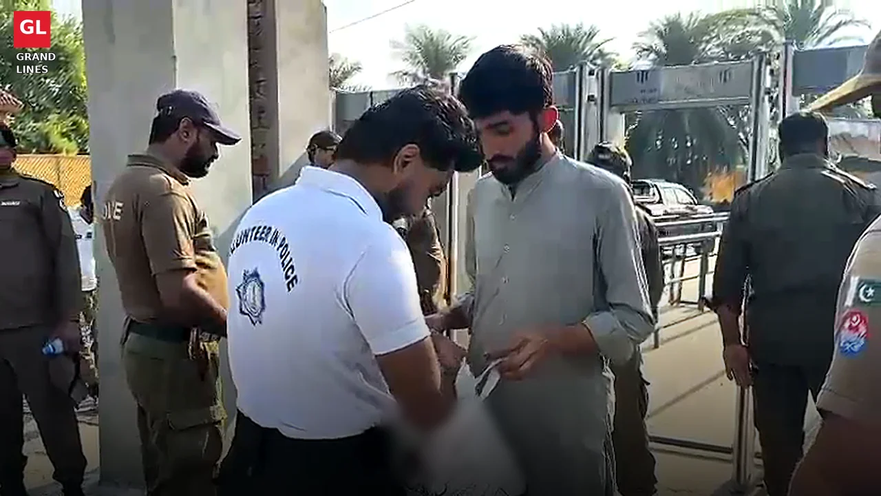 Student police volunteer checks a fan's bag at a walk-through gate outside Gaddafi Stadium in Lahore. Student police volunteer checks a fan's bag at a walk-through gate outside Gaddafi Stadium in Lahore.