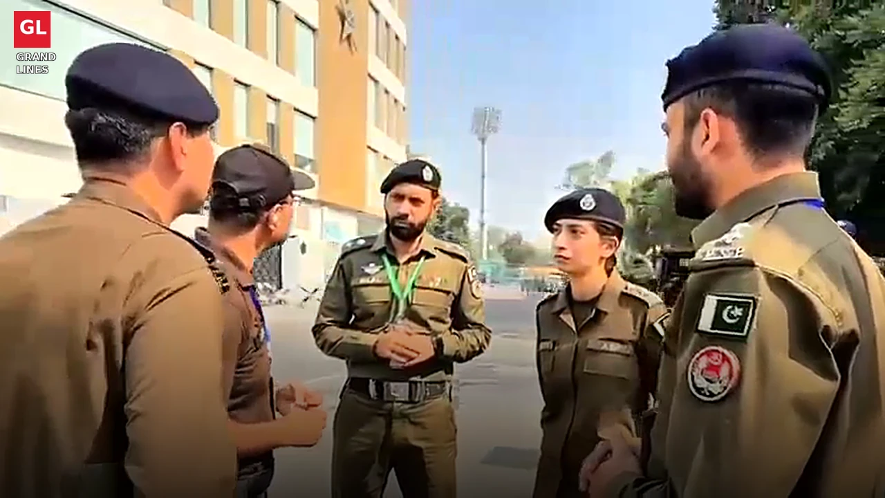 Police officers, including a woman officer, review security arrangements near Gaddafi Stadium. Police officers, including a woman officer, review security arrangements near Gaddafi Stadium.