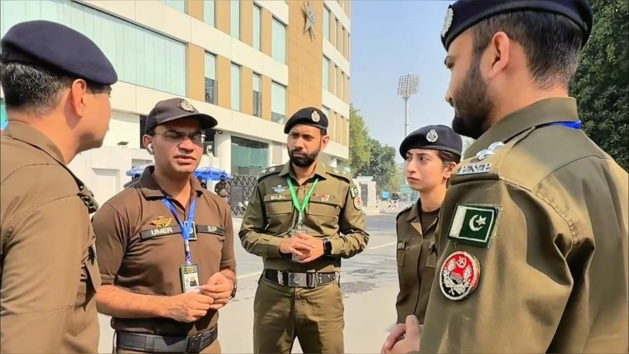 Officers briefing outside the stadium building at Gaddafi Stadium