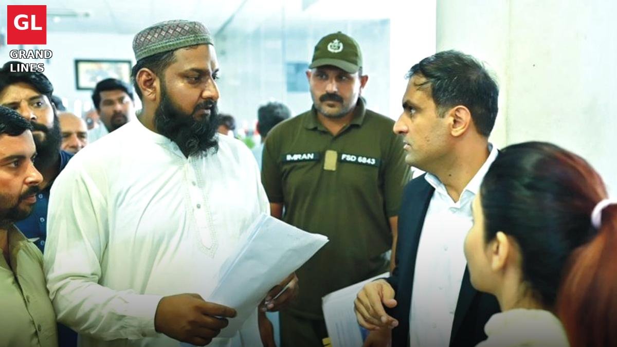Deputy Commissioner Muhammad Noman Siddique talks to an applicant at the Khidmat Markaz in Faisalabad