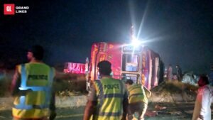 M-4 collision Sahianwala — overturned bus at night with police at the scene