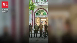 Police personnel stand guard outside a mosque in Faisalabad during Friday prayer security.