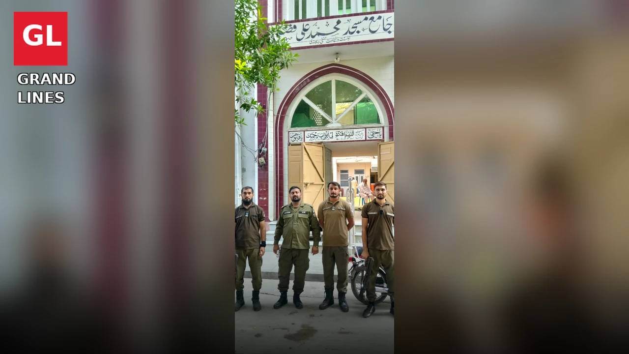 Police personnel stand guard outside a mosque in Faisalabad during Friday prayer security.
