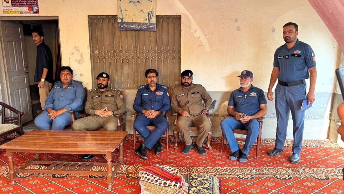 DSP Muhammad Saeed Gorsi with officers at the martyr's home
