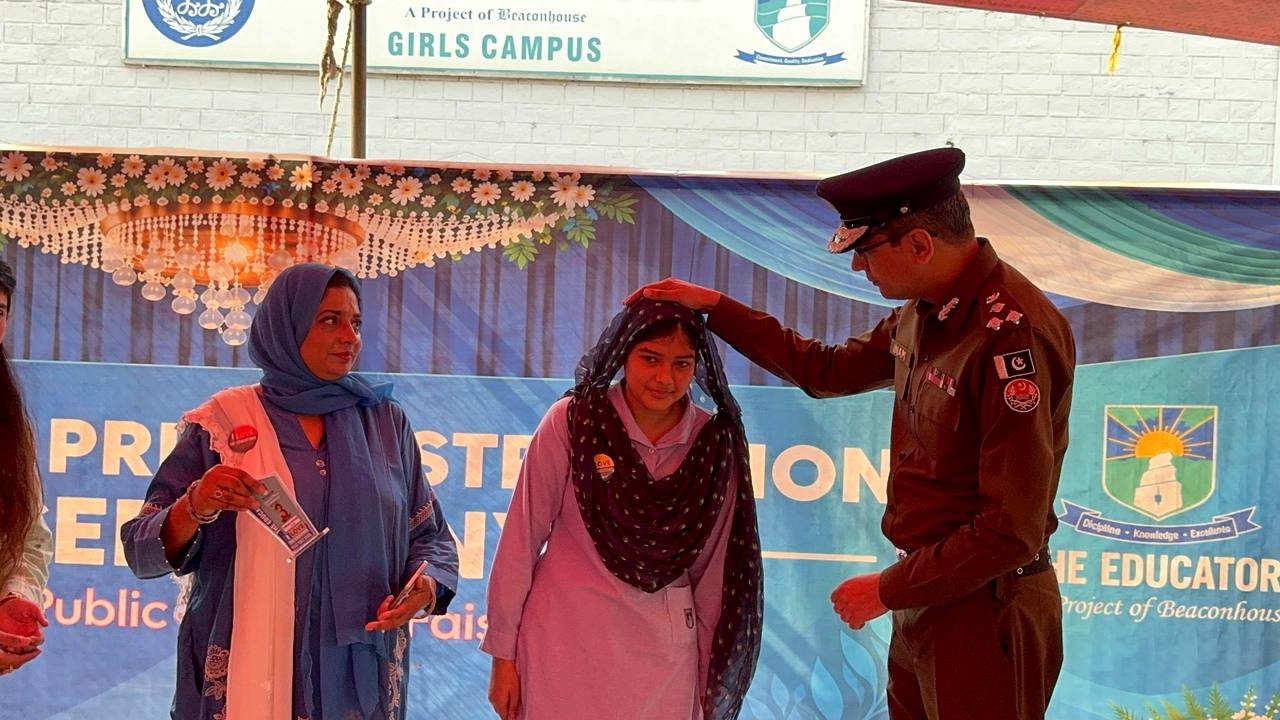 RPO Faisalabad Inam-ur-Rehman Malik blessing a position holder student at the prize distribution ceremony