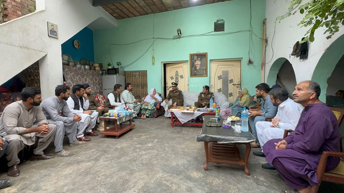 RPO Faisalabad and DPO Jhang sit with the family of martyred Constable Nasir Iqbal