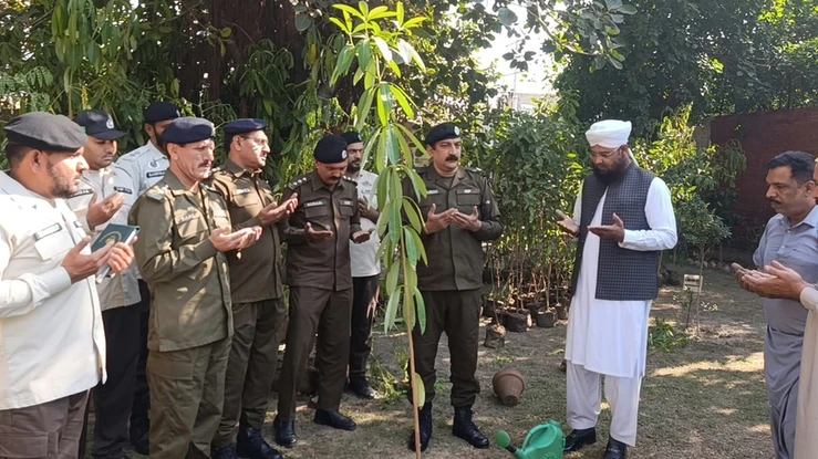Patrolling Police Faisalabad charge: officers pray at sapling planting ceremony. Patrolling Police Faisalabad charge: officers pray at sapling planting ceremony.
