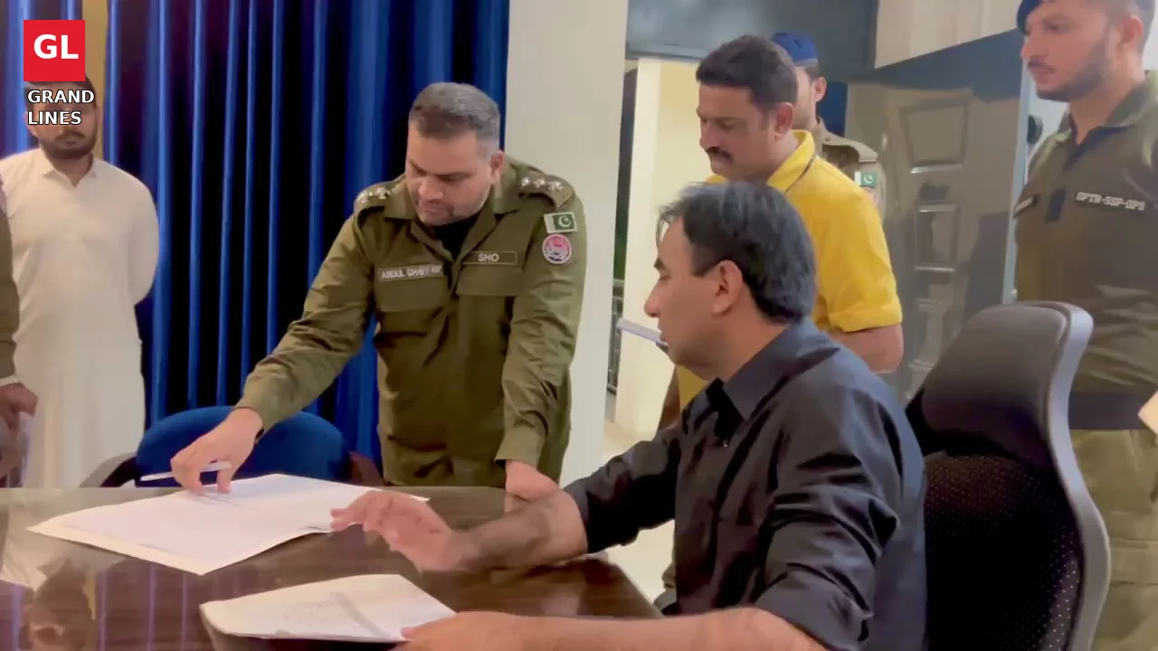 SSP Operations Imran Ahmad Malik reviews a register as the Gulberg SHO briefs him during the surprise inspection.