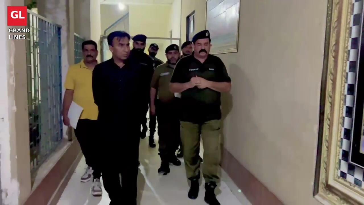 SSP Operations Imran Ahmad Malik walks through a police station corridor past the lockup during the surprise visit.