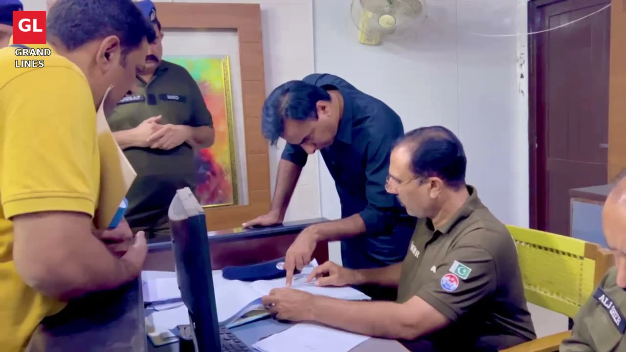 SSP Operations Imran Ahmad Malik examines station record while officers note his directions.