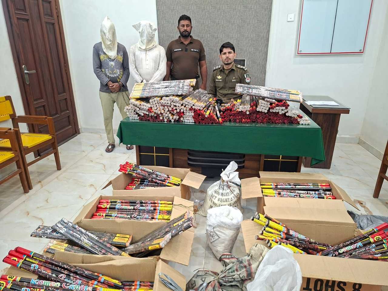 Seized fireworks material with arrested men and police officials