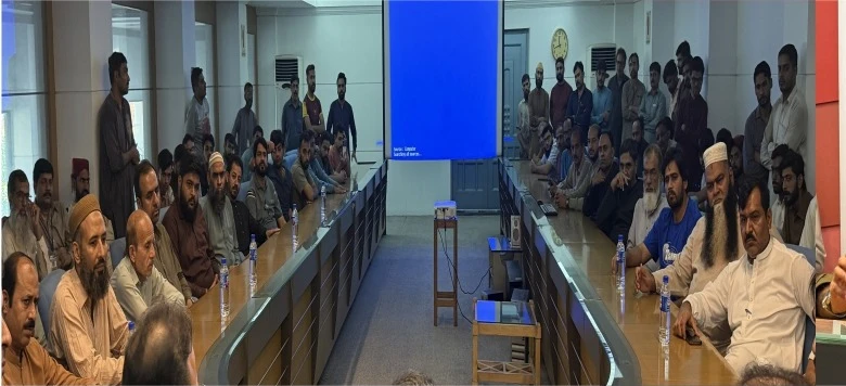 Traffic awareness session: Chenab Mills workers attend road safety lecture.