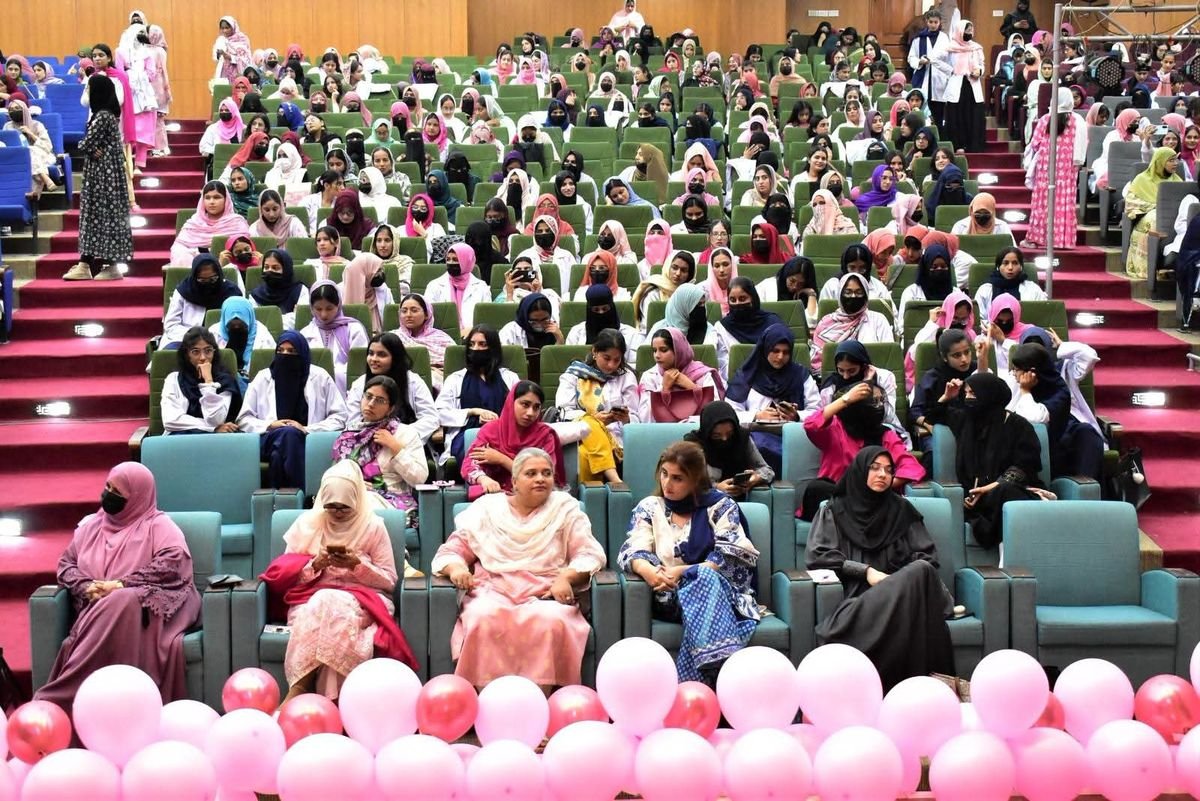 Audience at GCUF breast cancer awareness symposium with pink balloons