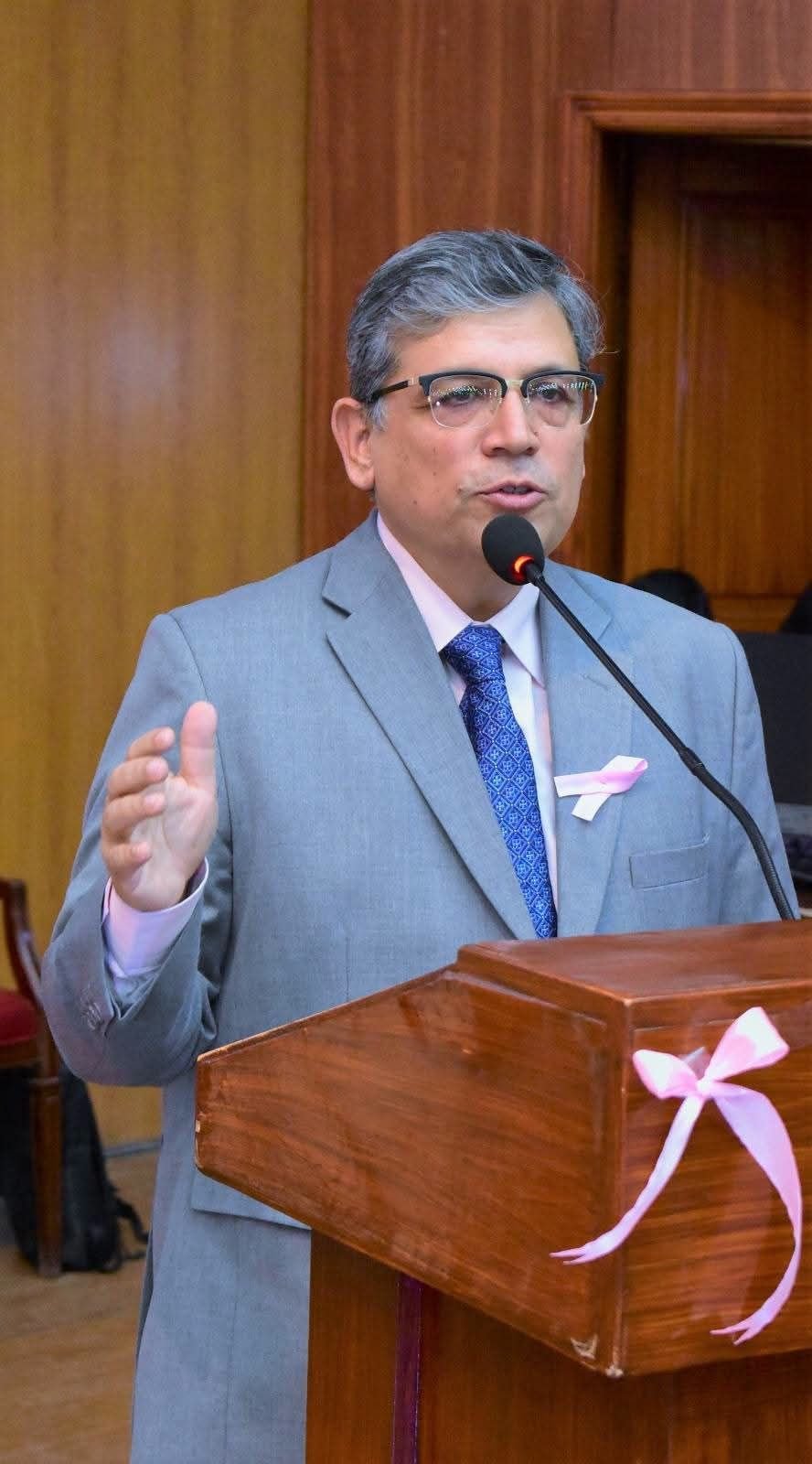 Speaker addressing GCUF breast cancer awareness symposium in Faisalabad