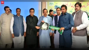 Senator Rana Sanaullah Khan hands over a green tractor key to a farmer under the Green Tractor Scheme in Faisalabad.