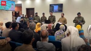 Police officers hearing citizens' complaints at an open court in Lahore