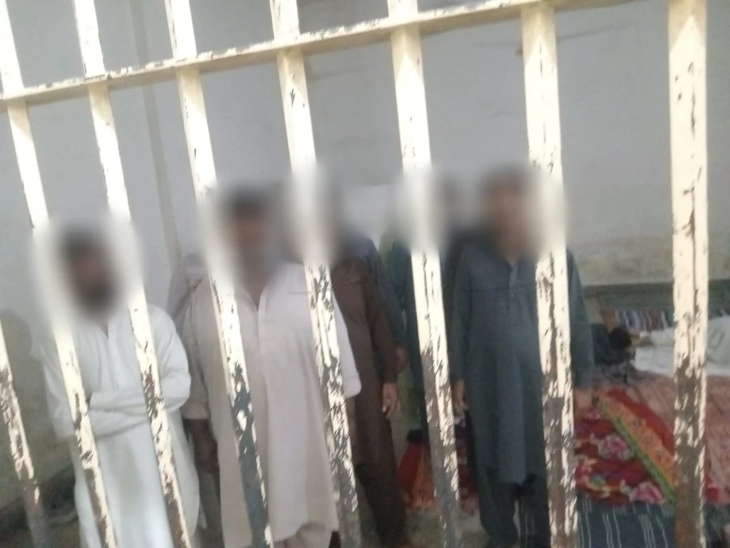 Arrested men inside a police lockup in Faisalabad.