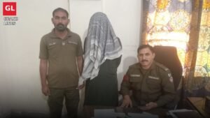 SHO Nishatabad Sajid Mahmood with arrested proclaimed offender Sharjeel at the police station in Faisalabad