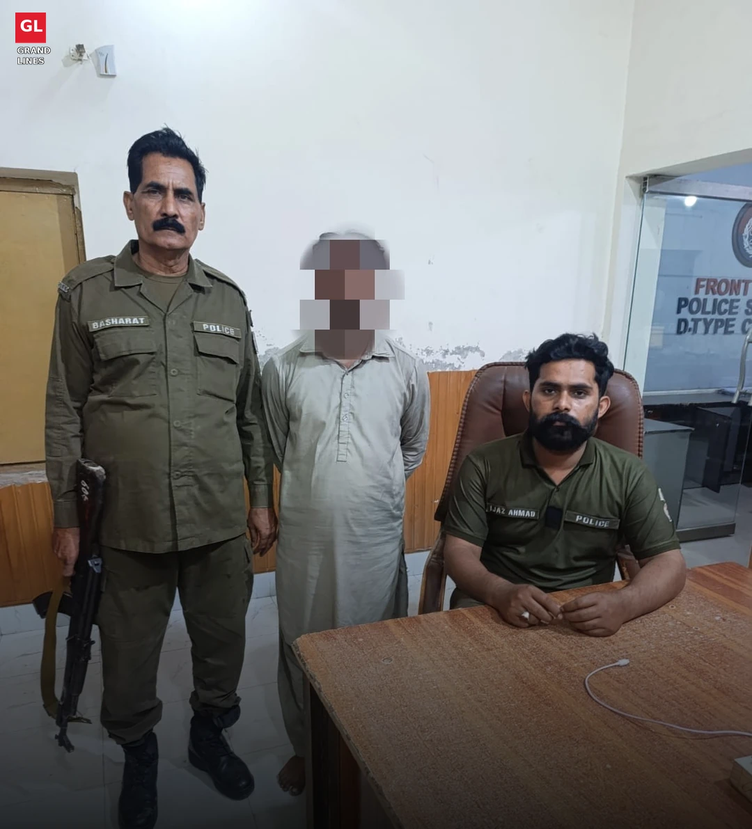 Arrested man at a Faisalabad police station front desk in the Samundri axe attack case