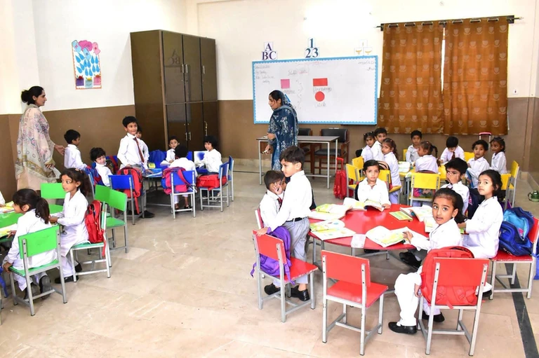 A wide view of a classroom during the vice chancellor's visit to the University Model School