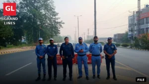 Traffic wardens manage traffic on a Faisalabad road during a diversion plan.
